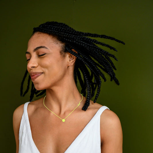 Redyoos Jewelry Recycling Black Model in White Dress with Redyoos Branded Graphic